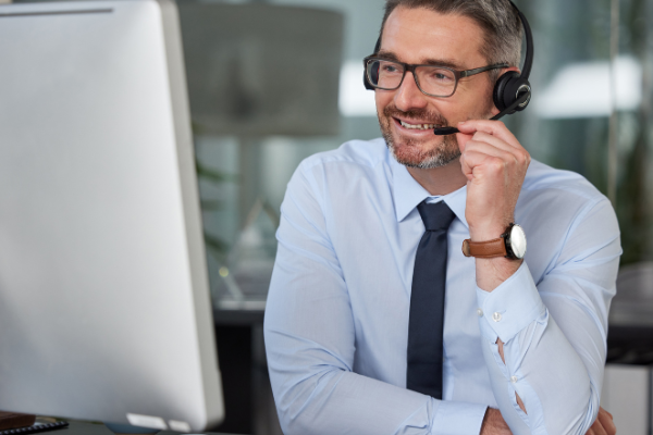 man customer service representative at a computer