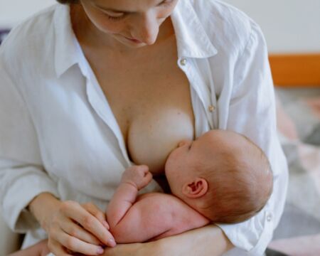 mother breastfeeding her baby Motherly