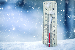 Thermometer on snow shows low temperatures - zero