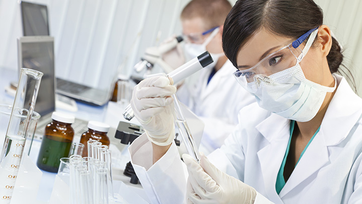 scientists inspecting test tubes