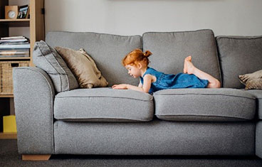 young girl lying on a coach 