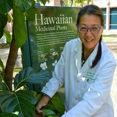 Dr. Mau in the Center's medicinal garden.