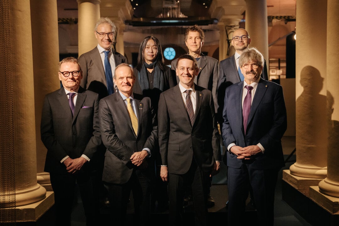 Seven men and one woman standing together