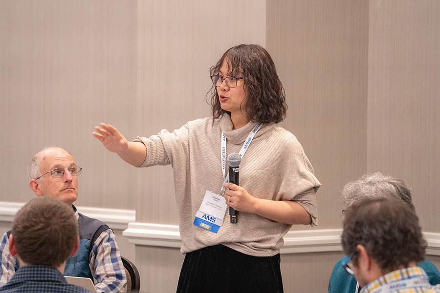 Xuguang Wang talking to a group of listeners.  