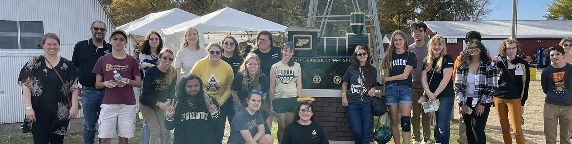 Pictured: banner image shows students standing in a line at Exploration Acres, Lafayette's local harvest festival farm