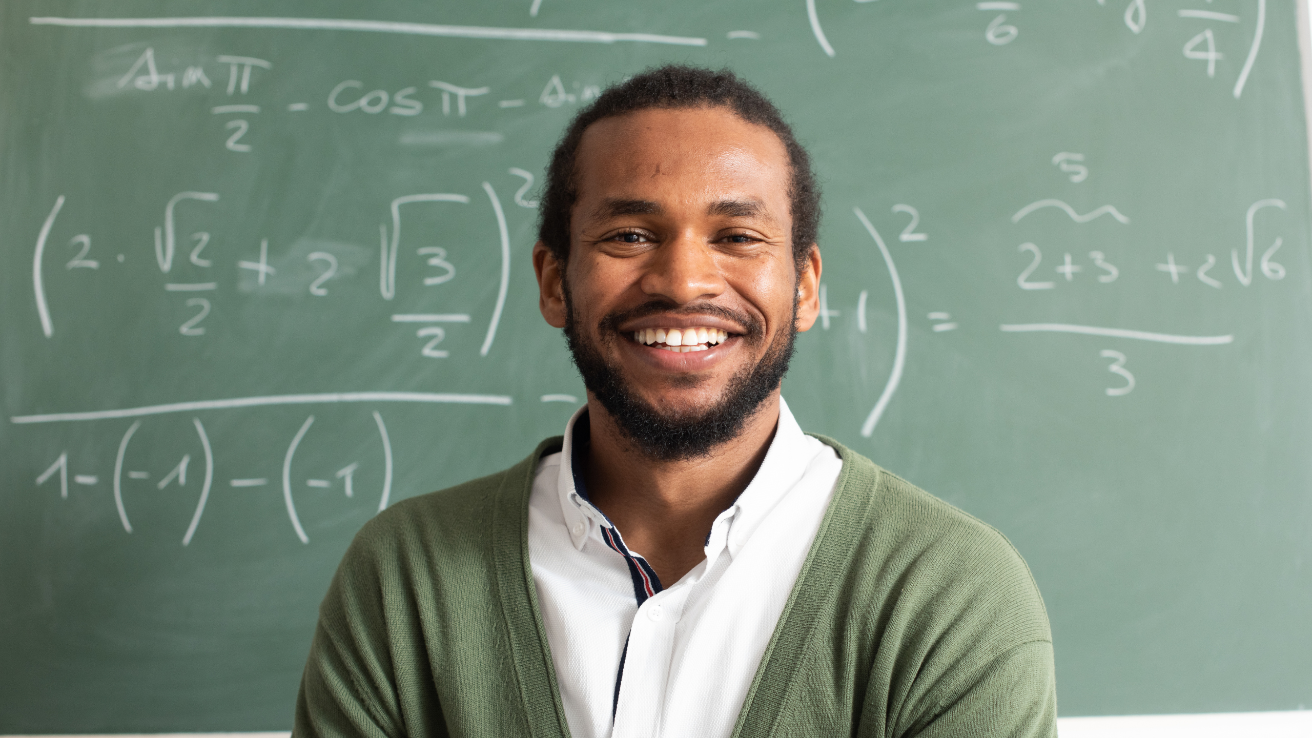 Man standing in front of chalkboard