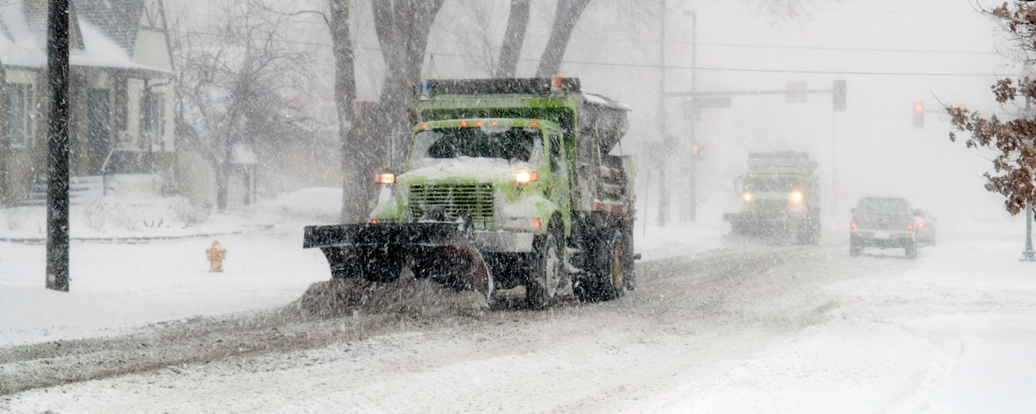 plow clears snow during a storm