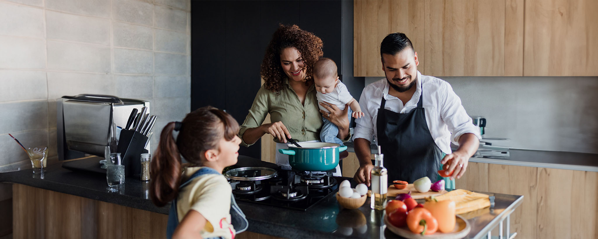 Hispanic family cooking in the kitchen. 