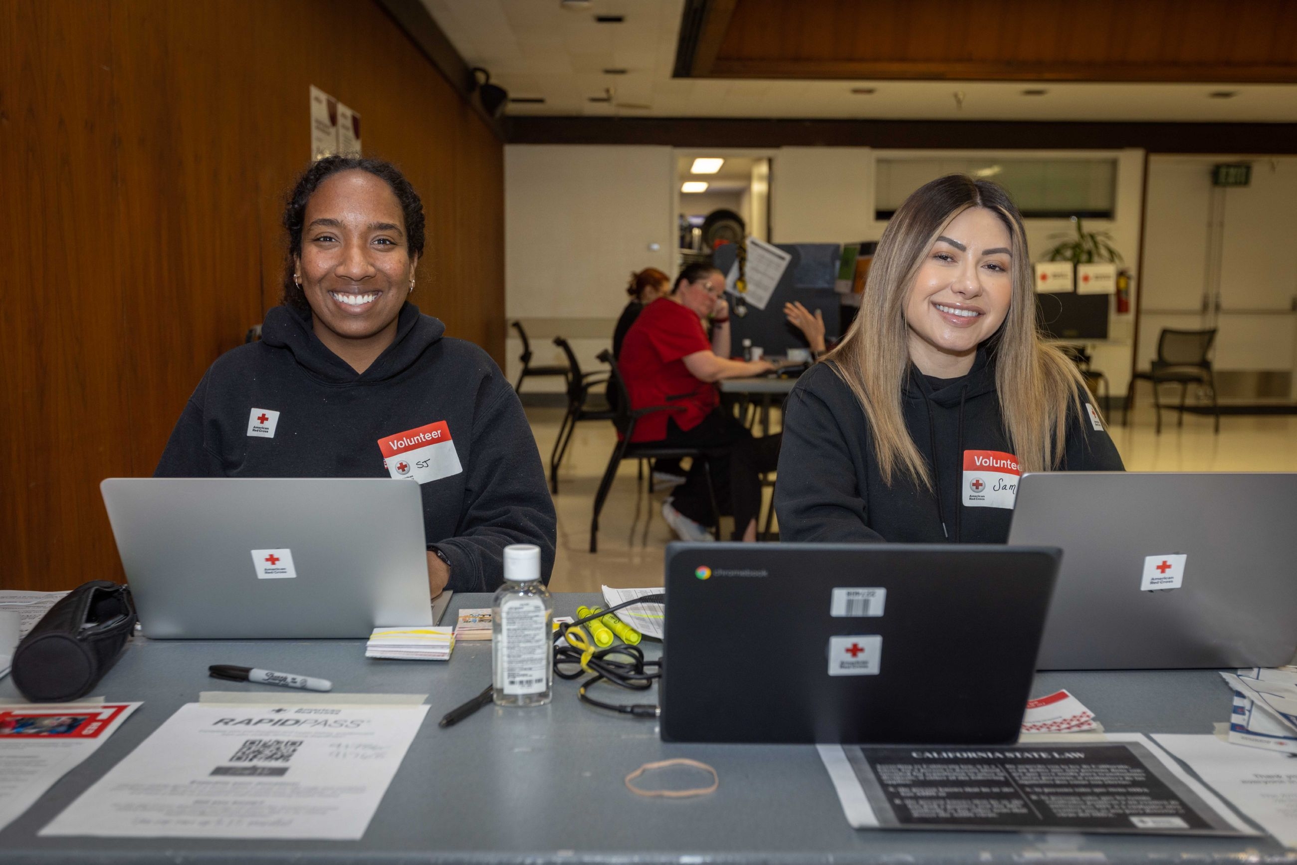 Red Cross employees working on computers.