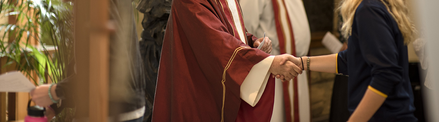 jesuit priest shaking hands