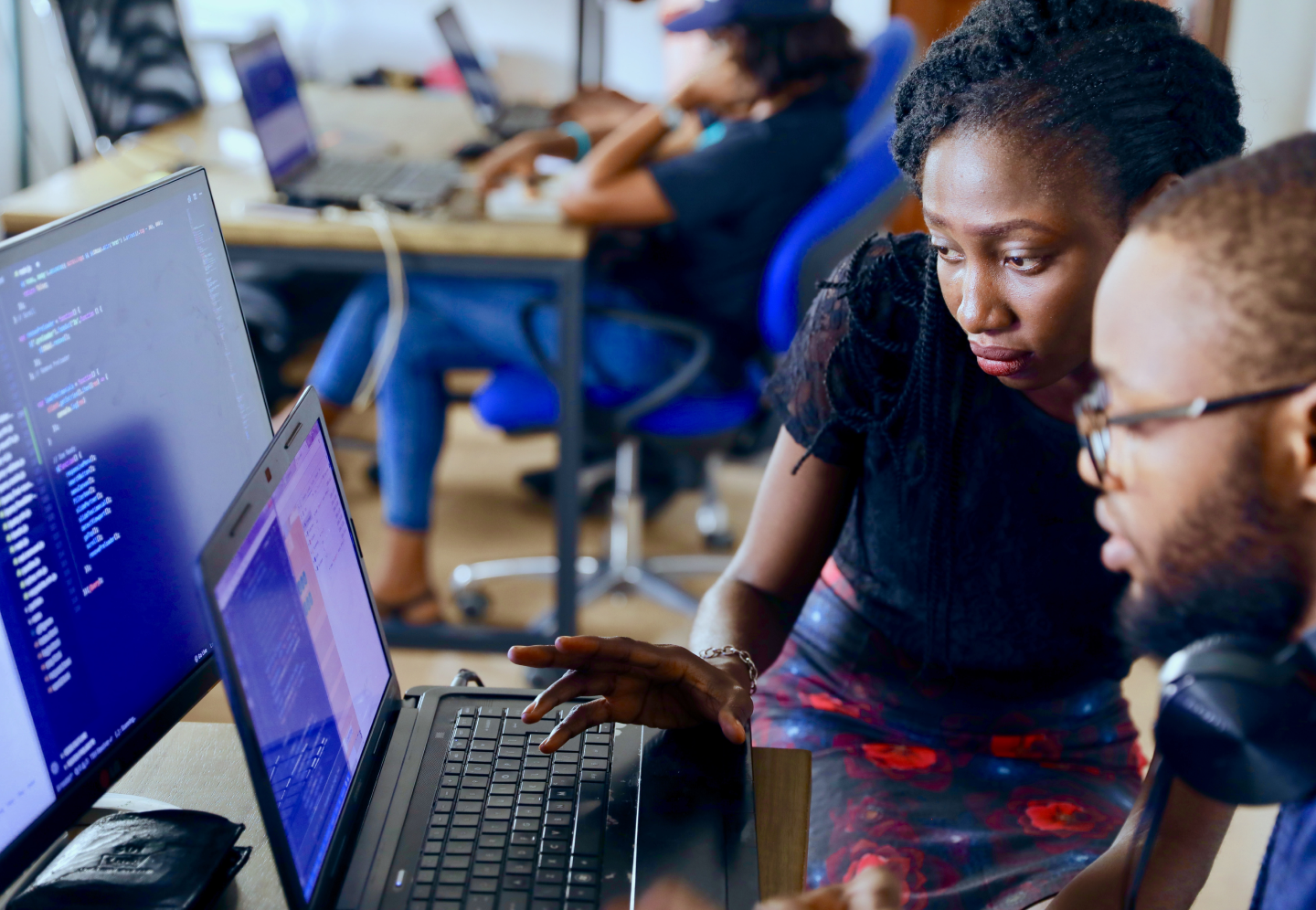 People working at two computer screens