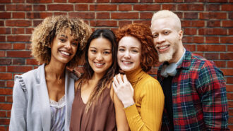 a photo of a group of multiethnic young adults, some with very coily kinky hair, one with curly hair and one with straight hair