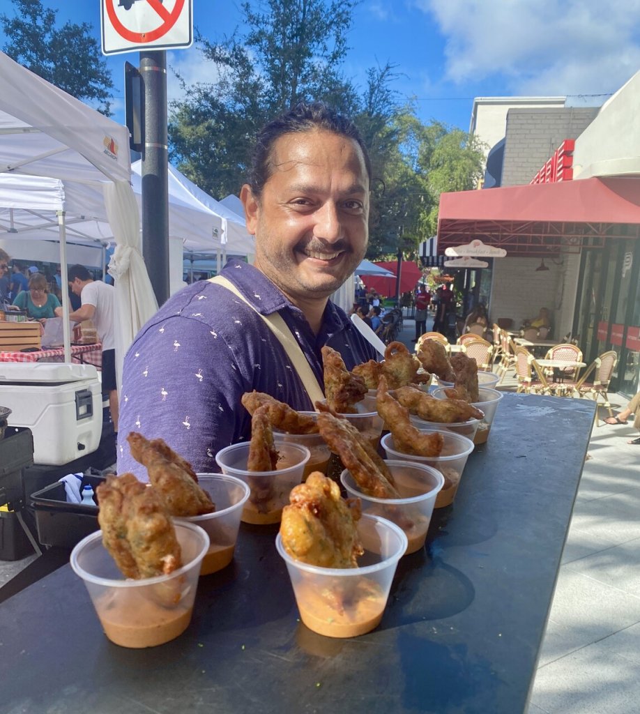 a tourist guide holding a plate of fried food