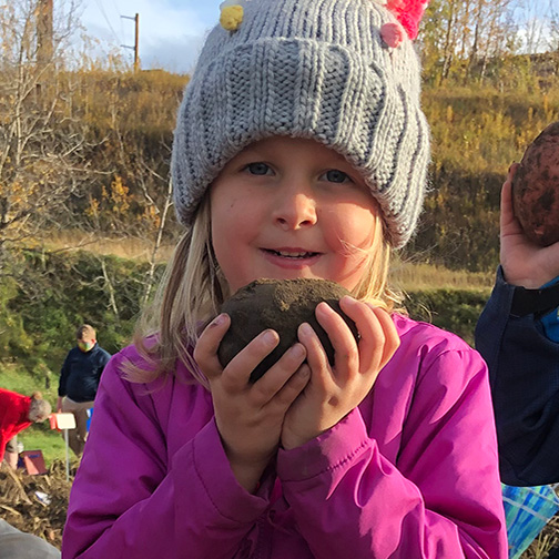 Girl holding a potato