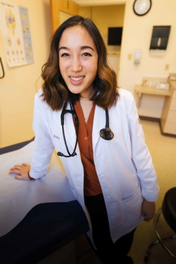 Physician Assistant student leaning on exam table