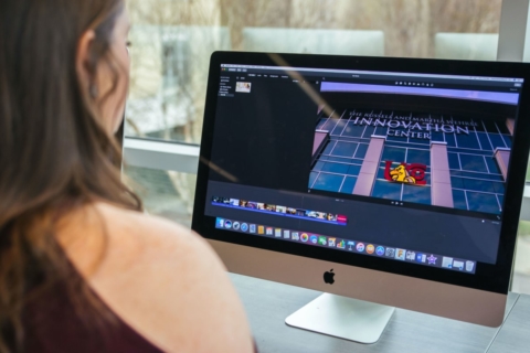 female student editing photos on computer in Innovation Center