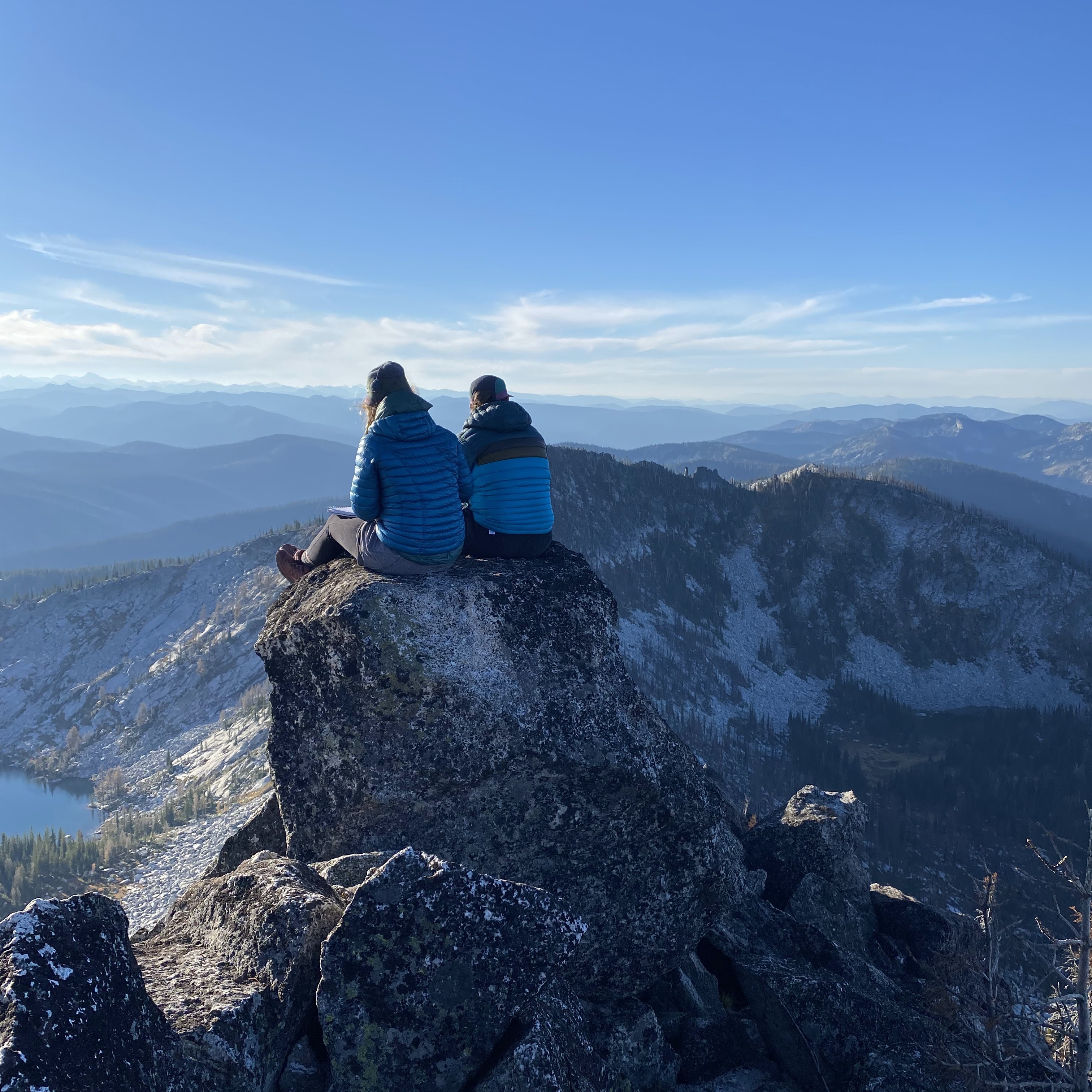 Two hikers at the top of a mountain