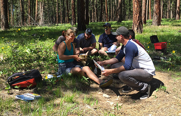 UM students attend class in a forest.