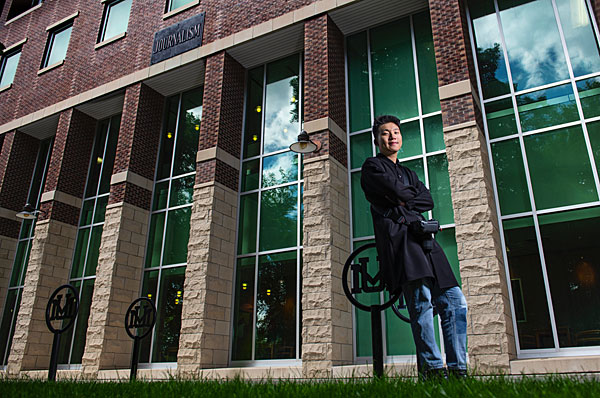 Jiakai “JK” Lou, a student in UM's School of Journalism, poses outside Don Anderson Hall.