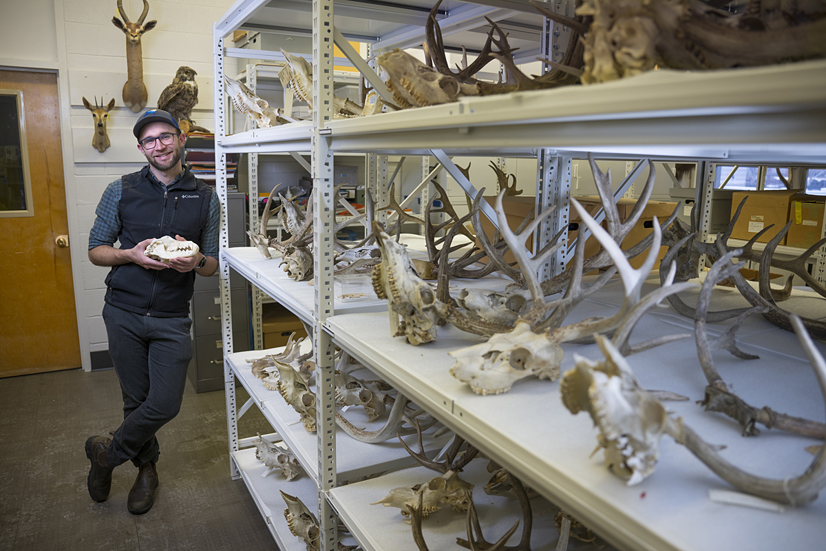 A picture of Connor Meyer holding a wolf skull.