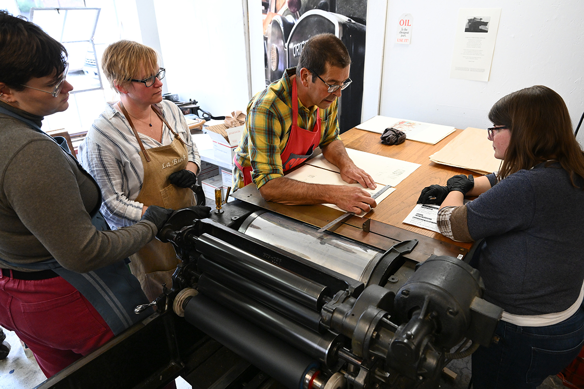 Photo of students around printing press