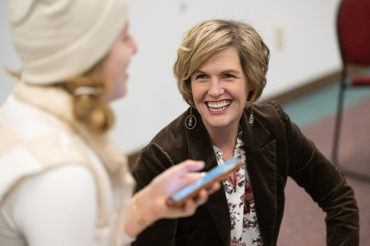 Heather Voorhees, a UM communication studies assistant professor, visits with a student in her new Health Misinformation class. 