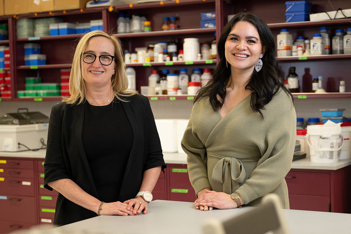 Researchers Erica Woodahl and Karen Brown pose for a photo in a UM lab.