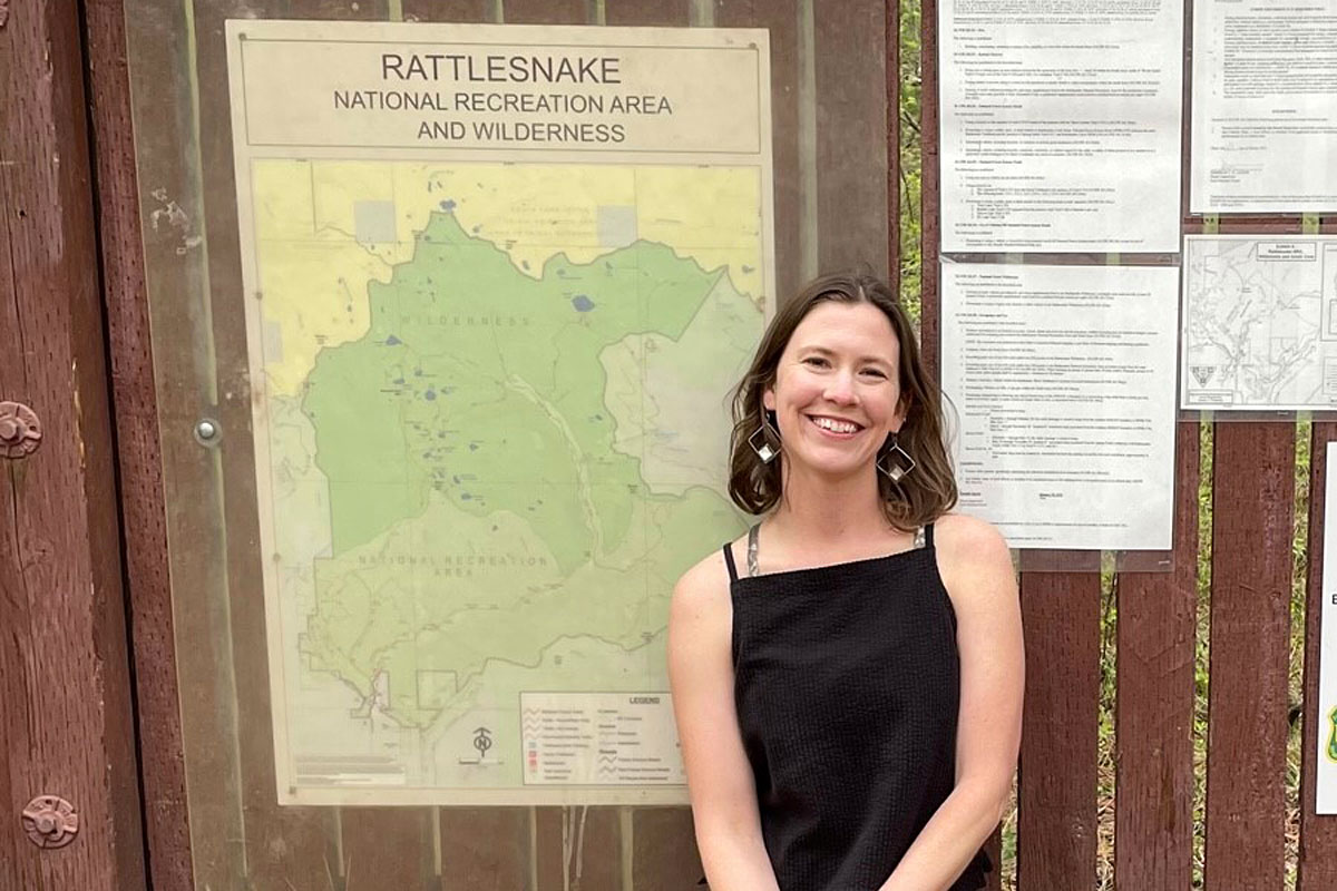 UM graduate student Elena Thomas poses at the trailhead for the Rattlesnake National Recreation Area and Wilderness near Missoula.