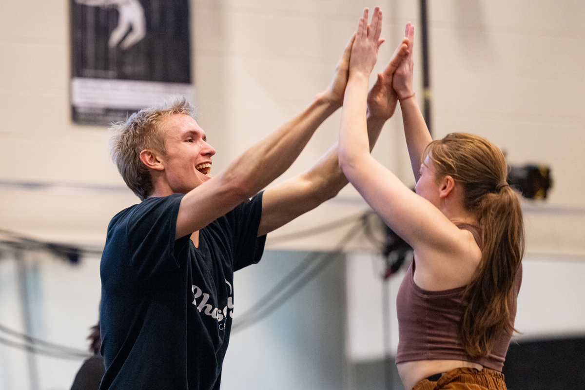 Students high five each other. 