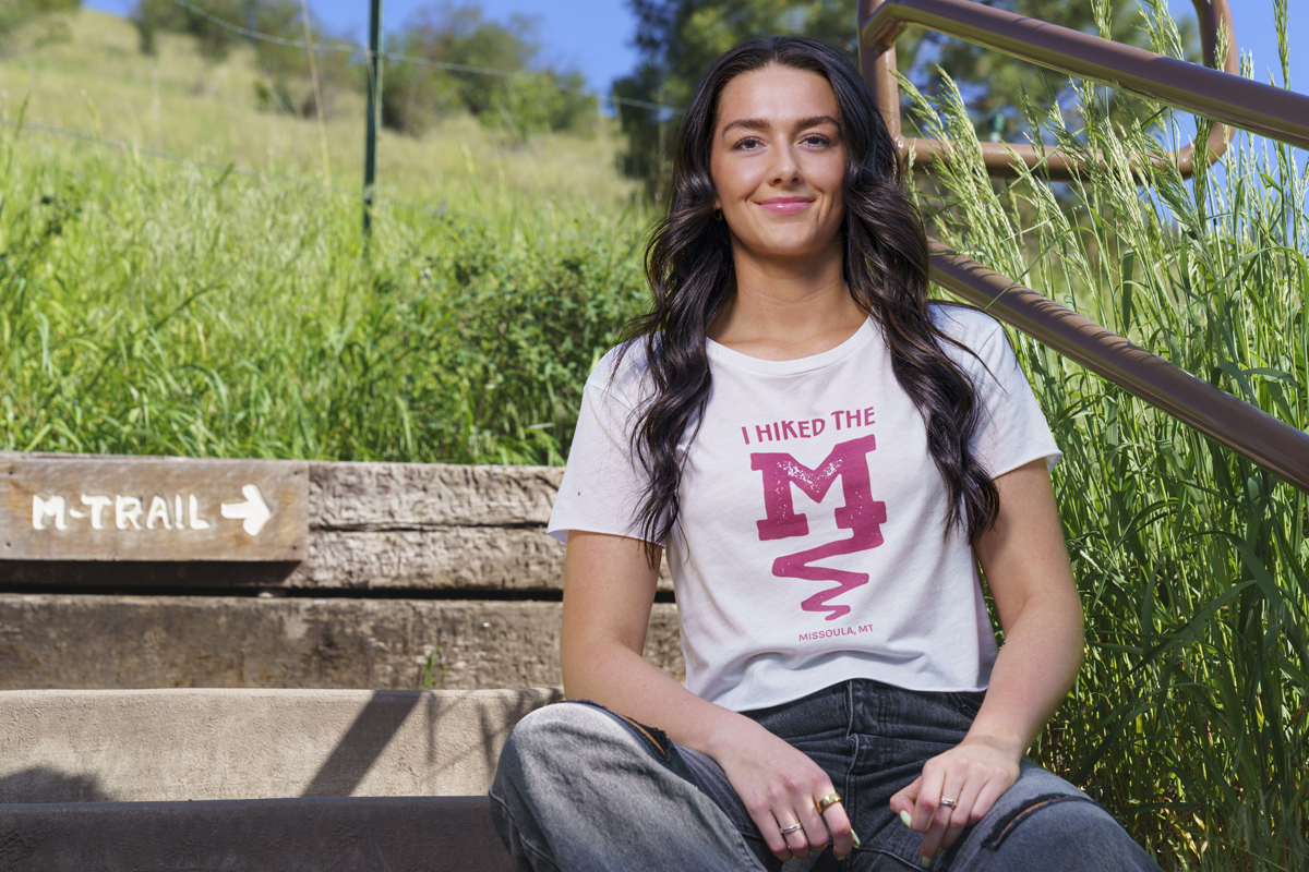 A girl wears the new M Trail shirt on the mountain