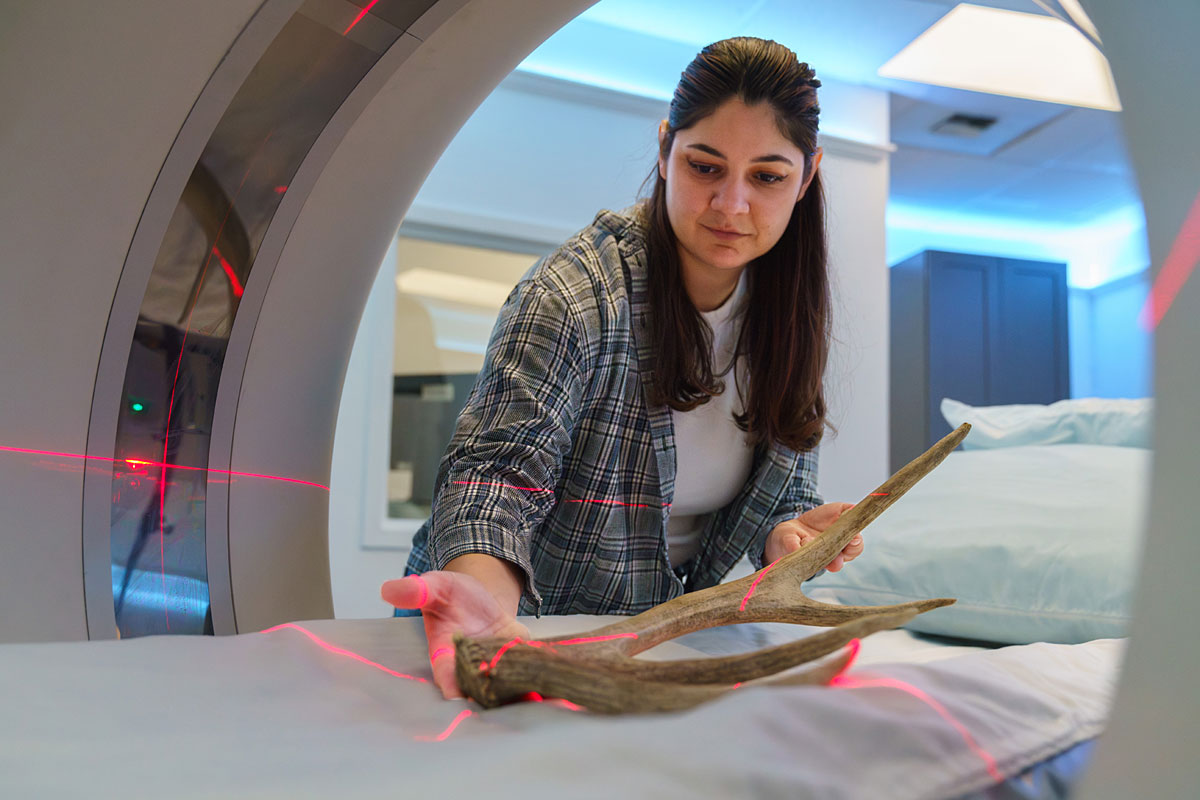 Nicole Lopez uses a CT scanner recently to analyze an antler in an area medical office.