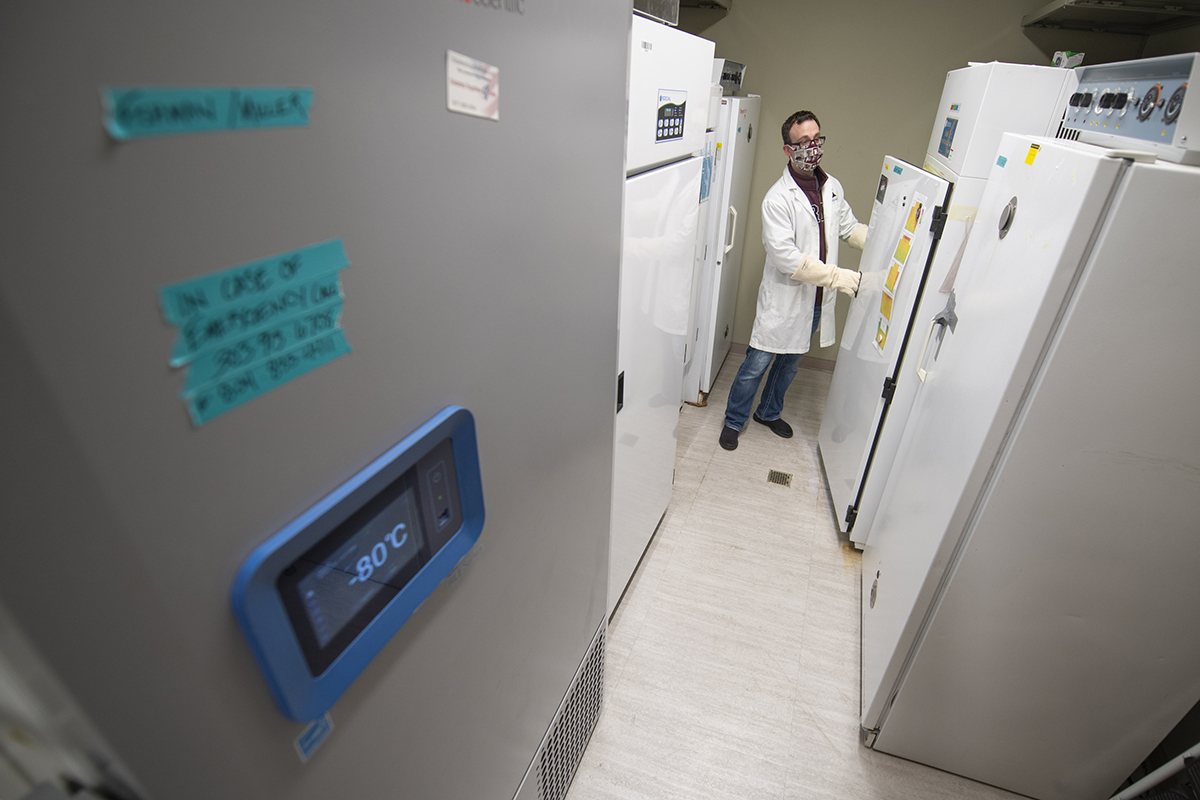 Kenneth Chatriand, pharmacist pharmacy manager, opens a subzero freezer. 