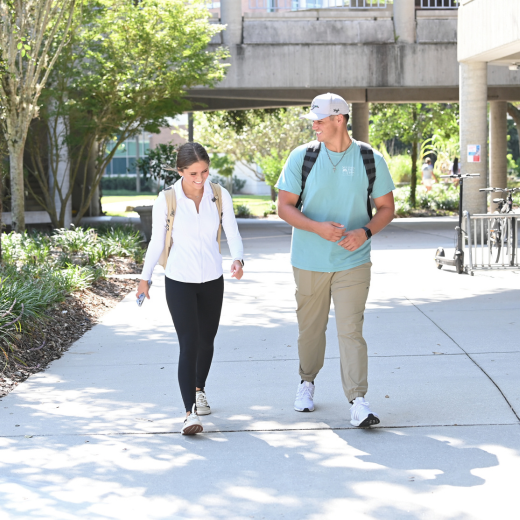 Action shot of students smiling and walking on their way to class