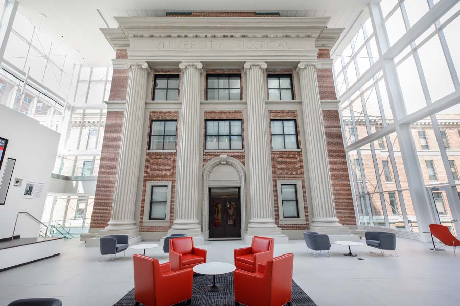 View of the glass atrium of the Wigton Heritage Center, which encloses the original front columns of University Hospital