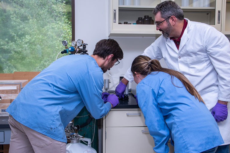 Research students working with Lee Leonard in lab