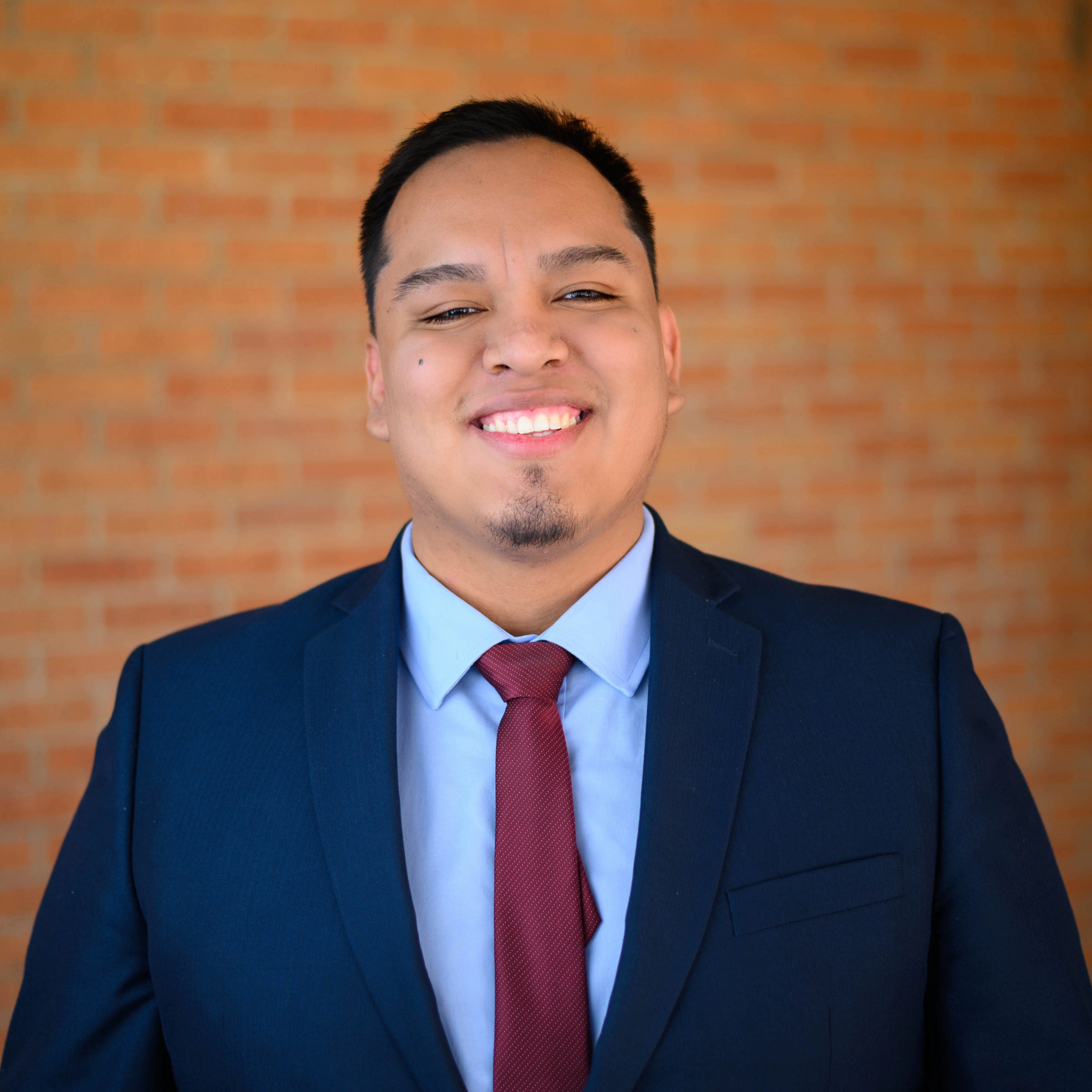 man in suit, smiling.