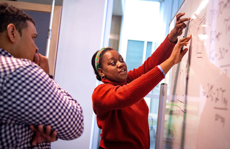 students working at a white board together