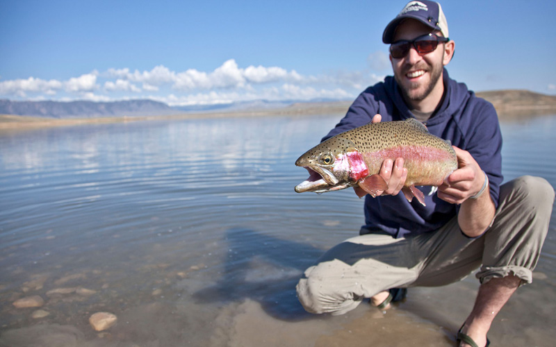 Male pictured with fish outside lake