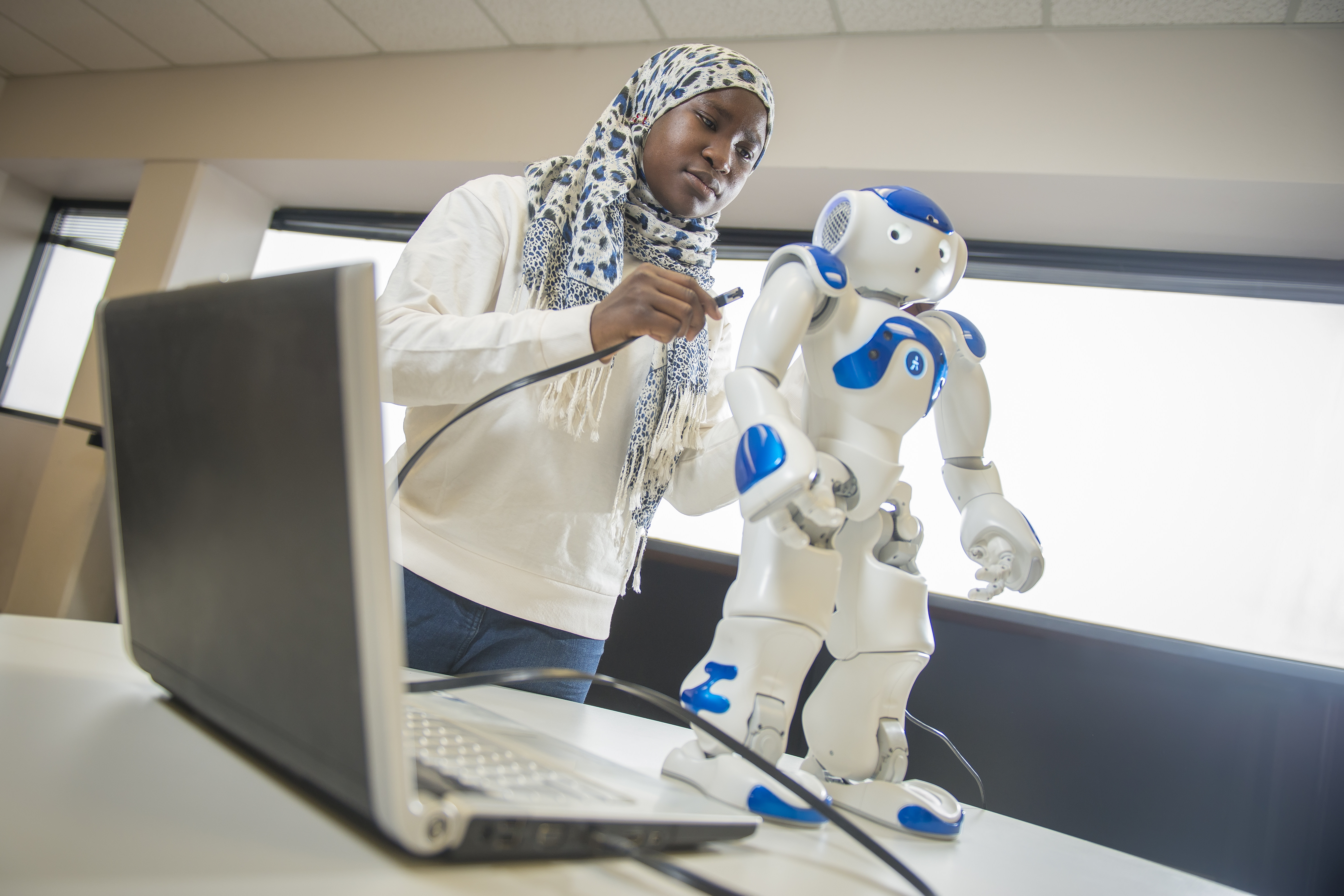 UW student working on a small robot.