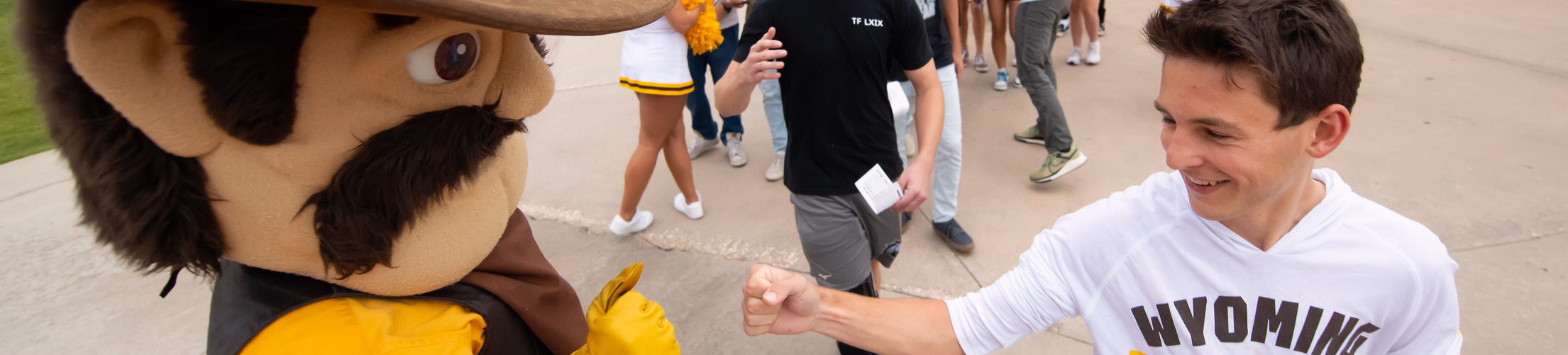 Student high-fiving Pistol Pete