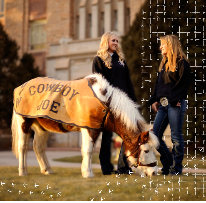 Two female students standing with Cowboy Joe