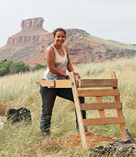 A student screening material at a site.