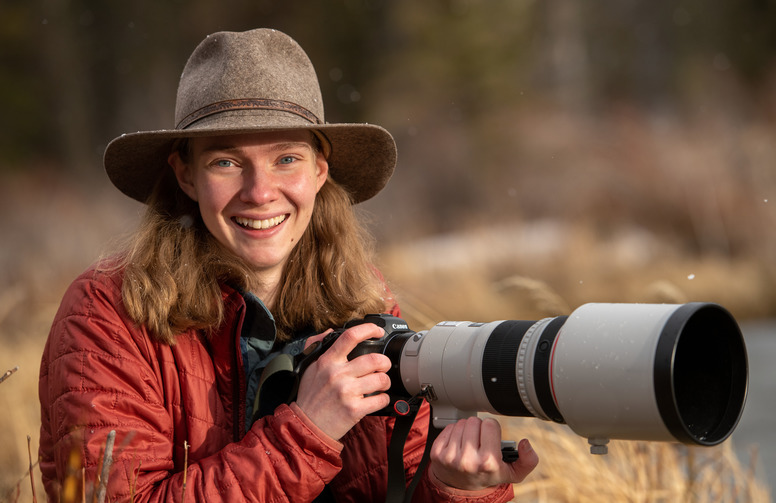 girl smiles with wide lens camera