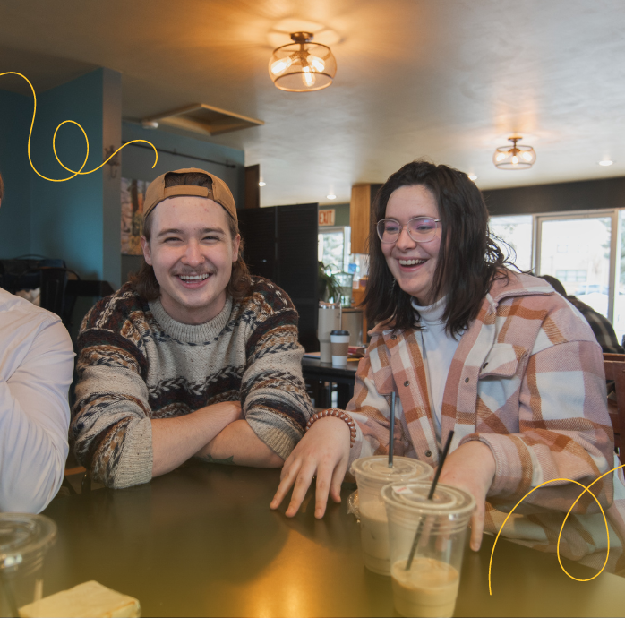 two students laughing at a coffee shop