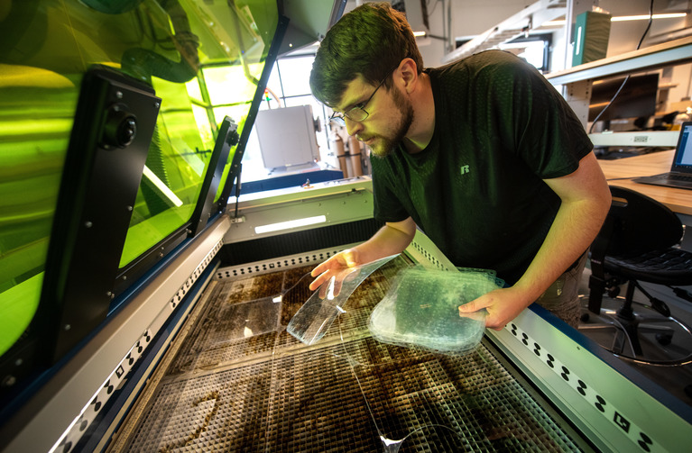 Student working on a large scale printer