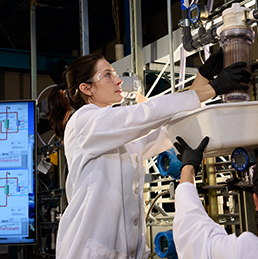 Savannah Bachman replaces a filter in Jonathan Brant's water lab.