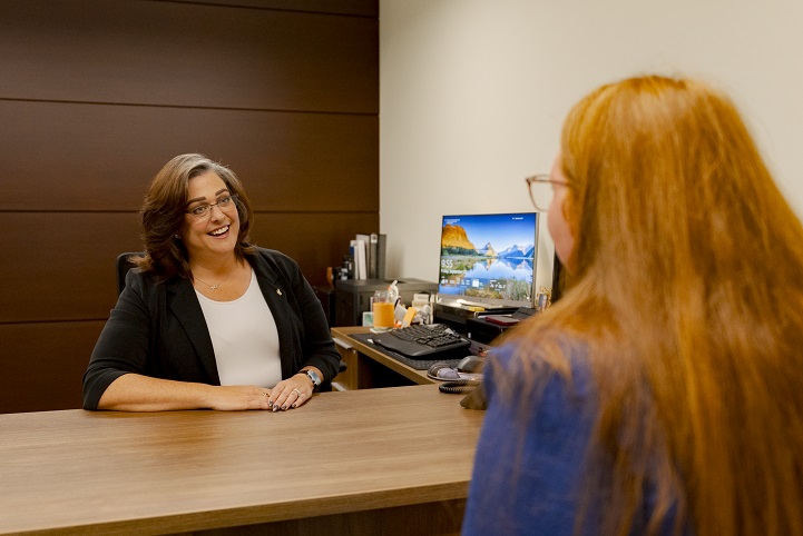 Admissions Director visiting with prospective student in office