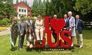 group of people gathered around an exterior sign