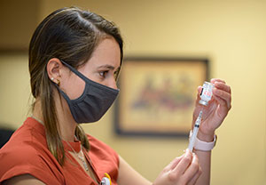 woman filling syringe