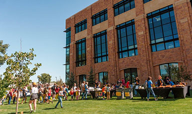 activity and display tables set up outside a large building